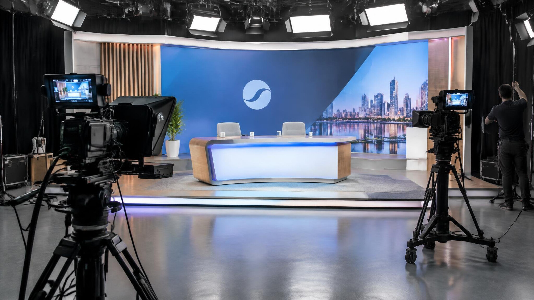 Empty broadcast studio set with desk and backdrop being prepared